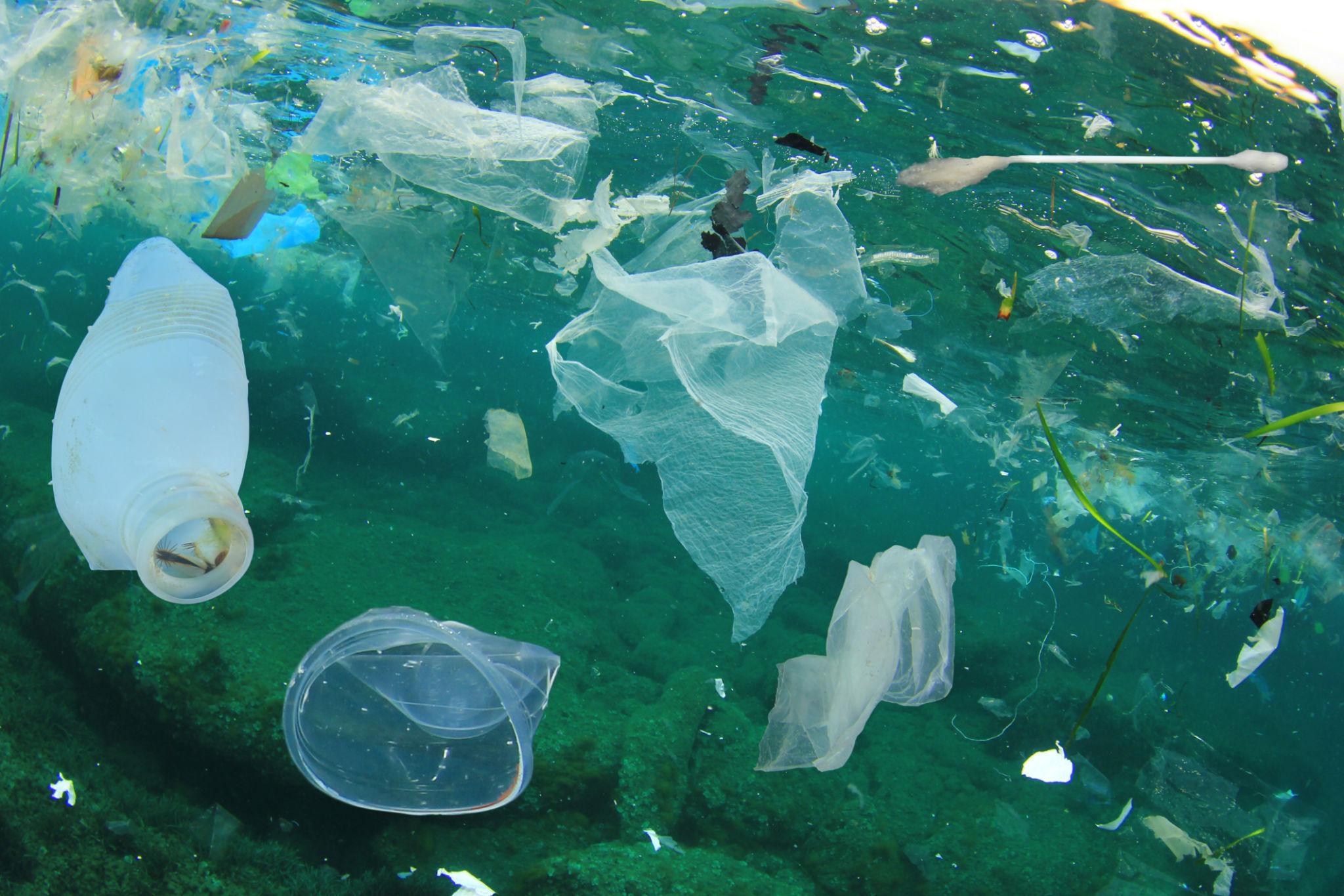 Plastic waste drifting underwater.